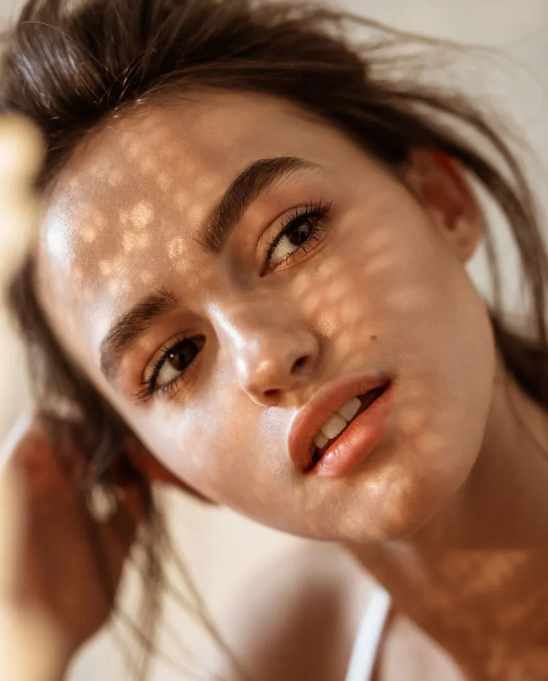 woman with shadows over face looking to the distance