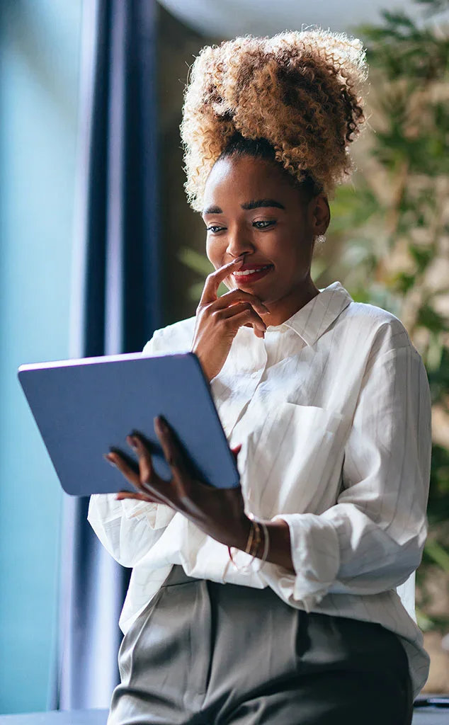 Woman reviewing insurance policies on her tablet