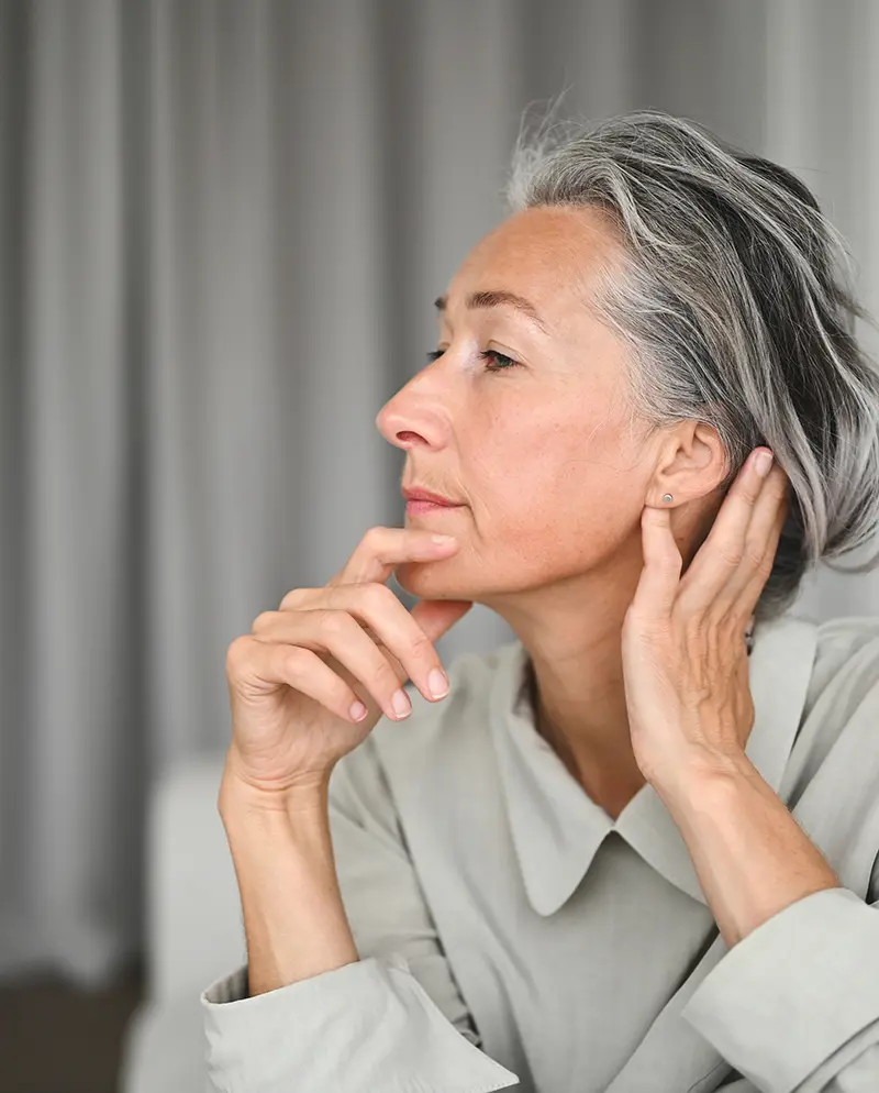 mature woman touching chin